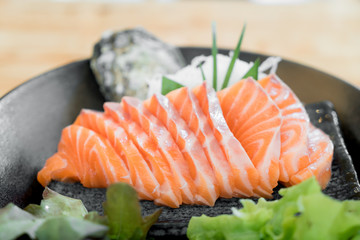 Japan raw salmon slice or salmon sashimi in Japanese style fresh serve on ice in Japanese restaurant.
