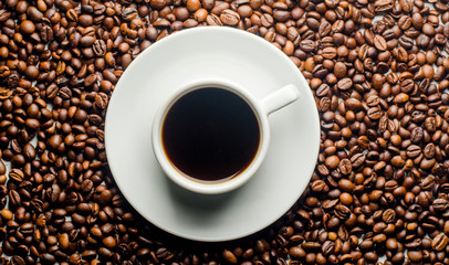 a cup of coffee, grains, books