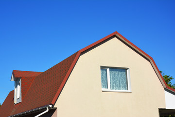 House Attic Dormer Window and Roofing Construction. Gable roof and dormer type of roof outdoors.