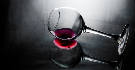 a glass of wine on a dark background