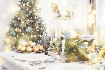 Table served for Christmas dinner in living room, close up view. Bokeh light soft effect