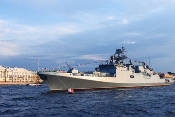 military ship on Neva river in St. Petersburg against the blue sky and the city