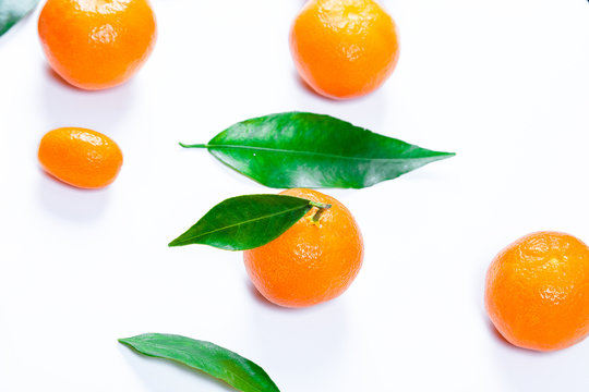 Mandarins fresh with leaves on a white background. Ripe delicious fruit. Symbol of the New Year and Christmas