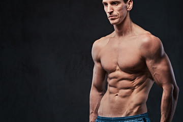 Fototapeta premium Shirtless muscular male over dark background.