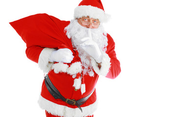 Real Santa Claus carrying big bag full of gifts, isolated on white background