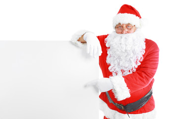 Santa Claus pointing in white blank sign with smile, isolated on white background