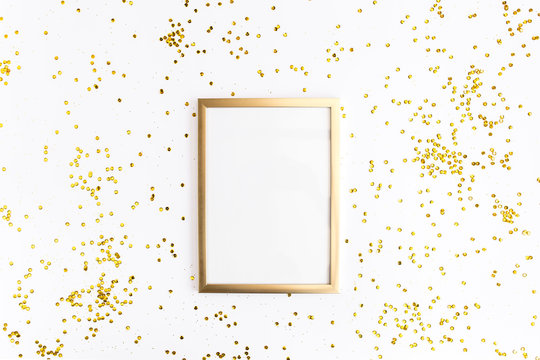 Photo frame mock up with space for text, golden confetti on white background. Lay Flat, top view. Valentine's minimal background.