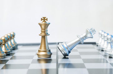 A conceptual photo with chess pieces on a chessboard. Business, law or political concept, which...