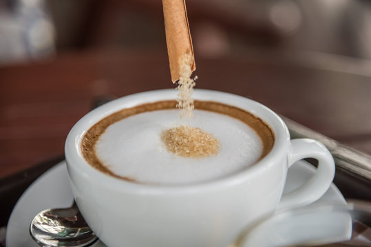 Pouring Red Sugar In To Coffee At Coffee Shop