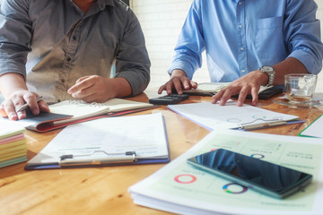 Image of young businessman using touchpad at meeting