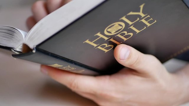 Man reading and studying Holy Bible