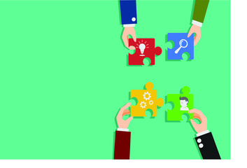 Hand holding puzzle pieces trying to connect each other. Business and teamwork concept