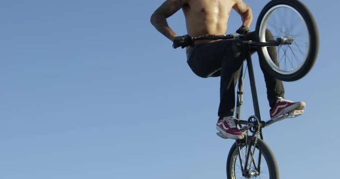 BMX rider does no hander trick - close up - 120fps slow motion