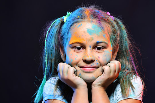 Children and creativity concept. Schoolgirl has paint spots