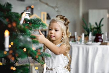 Christmas table: knife and fork, napkin and Christmas tree branch on a wooden table . New Year's decor of the festive table.