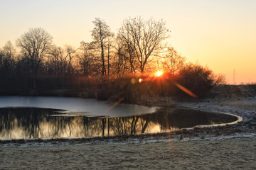 Sunrise at the frozen lake during winter