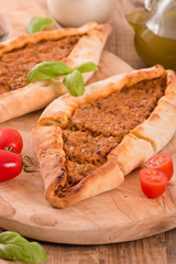 Turkish pide pizza with meat and onion. 