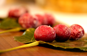 frozen red cherries desert with leaves decor on the table