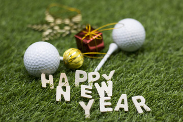 Merry Christmas and Happy New year to golfer on green grass with ornament