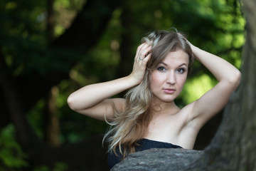 Naklejka premium Beautiful girl in black dress smooth her hair