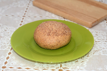 Bran muffin on the green plate on the table
