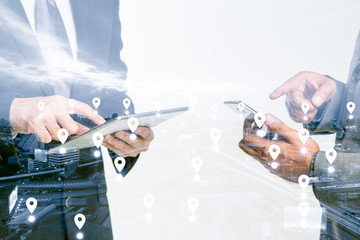 Fototapeta premium Double Exposure of a businessman use smartphone on blue tone city scape and network connection concept , Map pin business district backgroud
