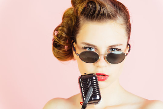 Woman singer with stylish retro hair and makeup.