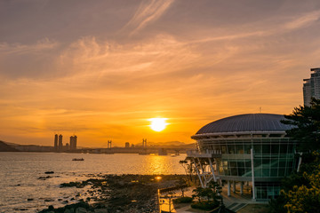 Busan Gwangan Bridge and Nurimaru APEC House sunset glow.