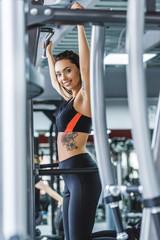 Fototapeta na wymiar athletic young woman doing pull ups at gym