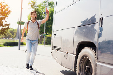 The guy runs after the bus that leaves. He missed the bus and tries to catch up with him. © Vadym Huzhva