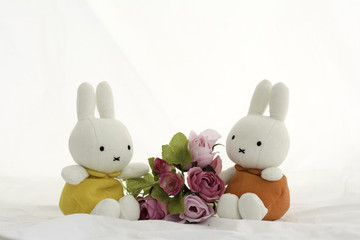 Lover Rabbit dolls  with bouquet of roses On a white background