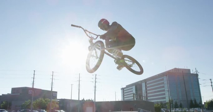BMX does a trick - toboggan - in front of fun - slow motion