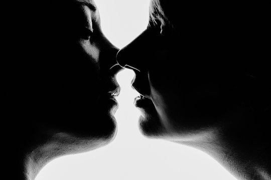 Silhouette of two beautiful woman kissing each other in passionate shot. Black and White shot. Concept Love without prejudice