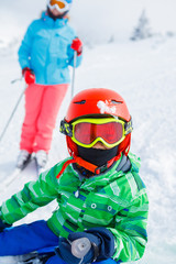 Fototapeta na wymiar Skier boy in a winter ski resort.