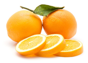 Oranges isolated on white background two whole with green leaf three slices.