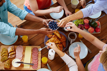 group of people having breakfast at table