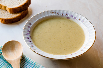 Broccoli Soup with Bread on Ceramic Surface.