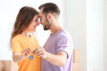 Young couple with key at new home