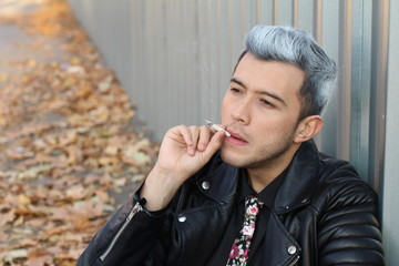 Alternative looking male smoking in the city