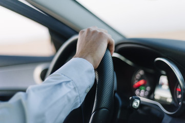 man hands holding steering wheel to drive