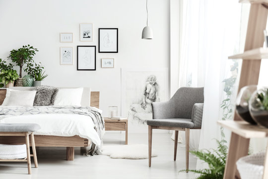 Grey chair in bright bedroom