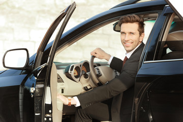 Man in formal wear getting out of car