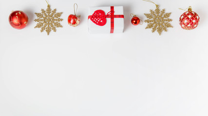 Christmas holiday composition. Festive creative gold red pattern, xmas handmade decor holiday ball with ribbon, gift, snowflakes, christmas tree on white background. Flat lay, top view