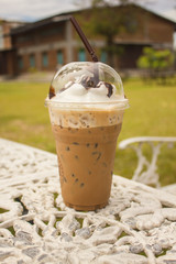 cold iced Coffee on  table in  coffee shop against blurred background.