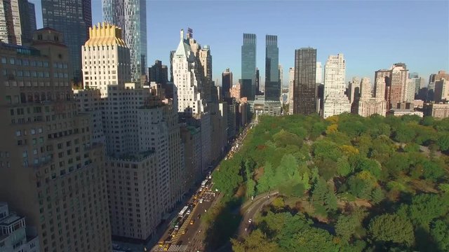 Aerial real time shot, camera is flying above Central Park along West 95th Street in New York.