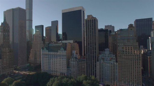 Aerial shot, camera is flying above Central Park and filming buildings on West 95th Street in New York. One of the most expensive real estate in the world