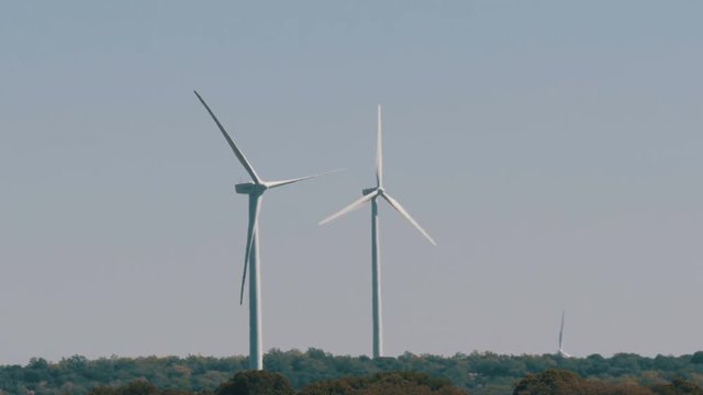 Wind energy turbines are renewable electric energy source. Electricity is generated by electric generators hidden inside turbine