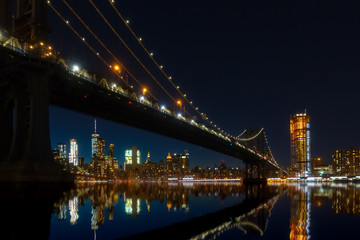 Fototapeta na wymiar New York City Panoramic landscape view of Manhattan with famous Brooklyn Bridge by night.