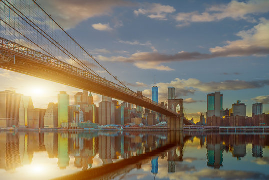 New York City Panoramic landscape view of Manhattan with famous Brooklyn Bridge at dusk . © bluebeat76