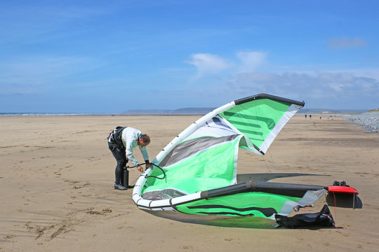 kitesurfer inflating his kite